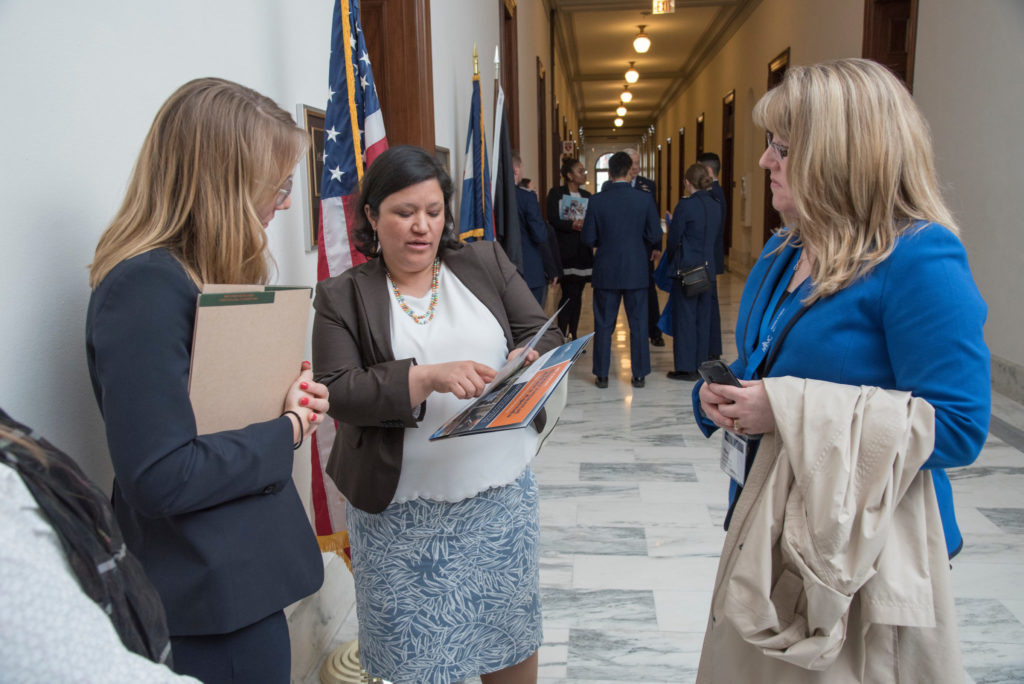 three woman standing in the hallway of the US Congress