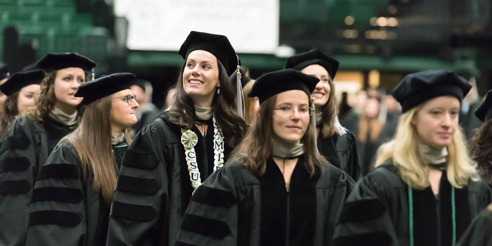 Graduates of CSU's Doctor of Veterinary Medicine walking out of Moby Arena after graduation