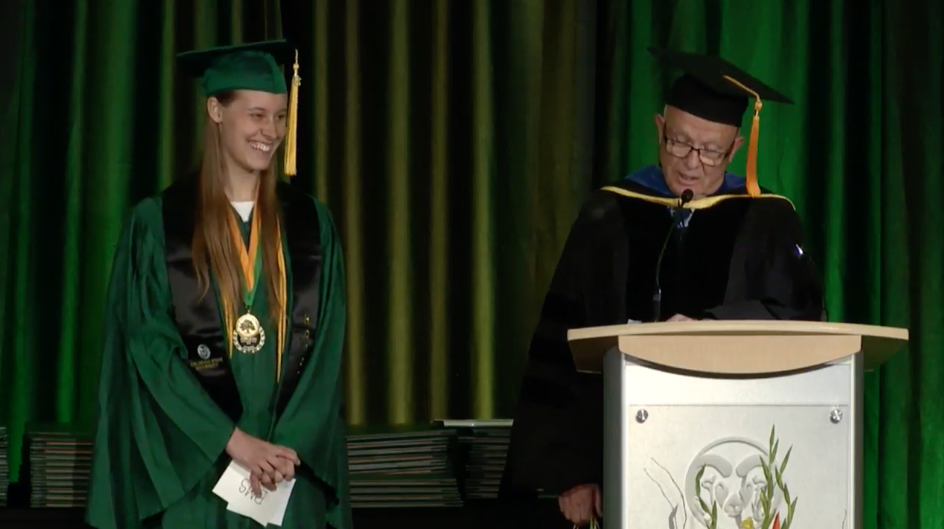 Stephanie Mills accepting her outstanding graduate award from CW Miller