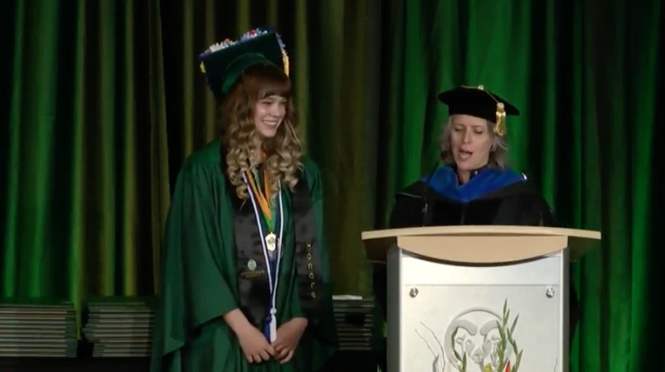 Emily Cunis accepting her outstanding graduate award from Judy Heiderscheidt