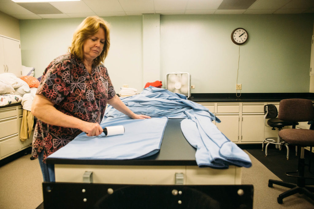 2:22 p.m. | Central Supply staff complete 30 loads of laundry per day. Since many patients at the hospital are furry, Diane Williams uses a lint roller to remove the fur from surgical drapes. Central Supply is also responsible for surgical instrument sterilization, delivering freight, and maintaining inventory.