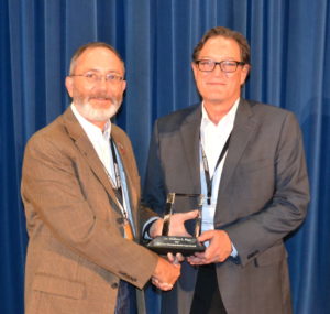 two men holding an award