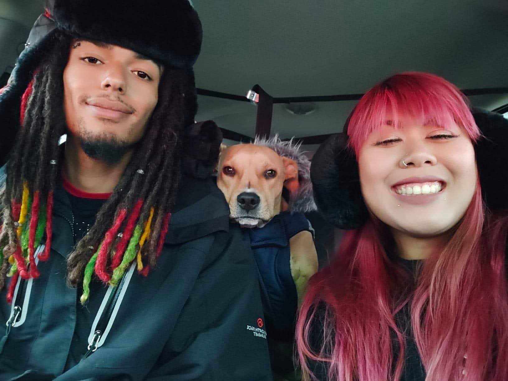 two people with their dog in a car