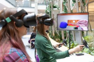 two women wearing virtual reality headsets