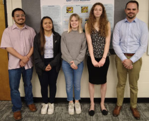 The students in Assistant Professor Carolina Mehaffy's laboratory research course proudly present the findings from their semester of research on computational protein modeling. From left: Andrew Wilson, Joanna Santibanez, Camryn Nesiba, Carole Ryan, and Kyle Hudick.